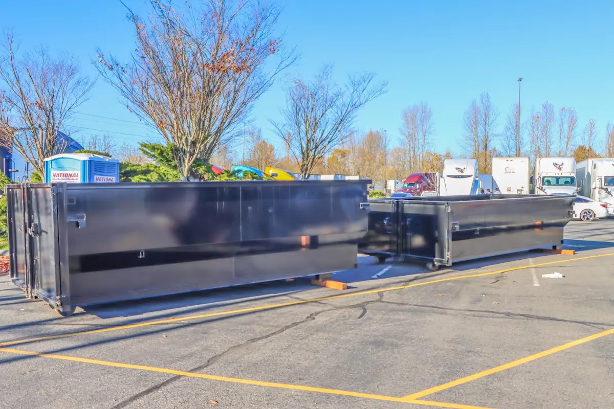 Professional dumpster rental service with roll-off container on residential driveway in Sarasota Springs